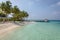 A beautiful bay inside a big resort in Maldives, green clear water with palm trees and blue sky