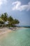 A beautiful bay inside a big resort in Maldives, green clear water with palm trees and blue sky