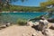 Beautiful bay, rocky beach and pines.