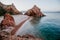 Beautiful beach with blue vivid turquoise water and red rocks