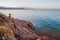 Beautiful beach with blue vivid turquoise water and red rocks