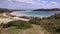 Beautiful beach das Conchas, with many kiosks by the sea and mountains in the background.