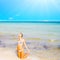 A beautiful beach with a kneeling girl