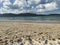 A beautiful beach landscape with mountains. Un hermoso paisaje de playa con montaÃ±as.