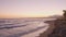 Beautiful beach next to the Mediterranean Sea at sunset. Marbella, Spain. Waves crashing on the beach. Empty sea front