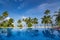 Beautiful beach and pool. View of nice tropical beach with palms around. Holiday and vacation concept. Tropical beach