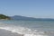 Beautiful beach in southern Brazil - City of Florianopolis. Beautiful view of greenish sea. Cloudless sunny day - clear sky in the