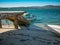 Beautiful beach with stone jetty and boats in Algarve, Portugal.