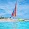 The beautiful beach of Varadero in Cuba with a colorful sailboat