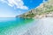 Beautiful beach and water bay in the greek spectacular coast line. Turquoise blue transparent water white pebbles, Greece summer