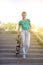 Beautiful beautiful girl rides on highway on Longboard scenic street. Solar toning. A close-up portrait