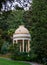 Beautiful beige round arbor with a dome in the Sochi Botanical Garden. Russia