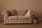 Beautiful beige textile sofa chesterfild in the interiors