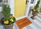 Beautiful beige Welcome zute doormat with Border outside home with yellow flowers and leaves