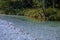 Beautiful Belca river, small clean water stream in the narrow valley of belca river, Slovenia. Grass on the riverbank, slow