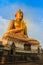 Beautiful big golden Buddha statue on the hilltop at Wat Khao Ba