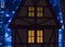 Beautiful big house decorated with Christmas lights. Large Windows with Christmas tree.