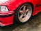 Beautiful big racing wheels of a sports red car with a very low ground clearance on cast shiny expensive alloy wheels in the style