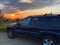 Beautiful black car Jeep stands on the road against red sunset at the Adriatic sea, coast in Slovenia at summer