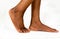 Beautiful Black female Flat feet with smooth skin. African American woman healthy foot baby. Feet of baby`s naked isolated on whit