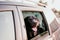 Beautiful black labrador dog in a car ready to travel. Pets traveling concept