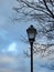 Beautiful black lamp , tree and cloudy sky