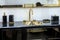 A beautiful black marble washbasin with a gold tap and fittings. Gold sink, led mirror, marble black dispensers