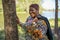 Beautiful black plus sized model posing by a tree in a tranquil park scene