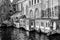 Beautiful black and white image of a canal with brick houses