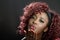 Beautiful black woman on black background blowing a kiss. Afro h