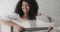 A beautiful black woman playing the guitar and enjoying a quiet time at home