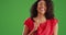Beautiful Black woman with radiant smile twirling on greenscreen background