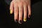 Beautiful black-and-yellow manicure with shellac varnish in the form of a sign of radioactive danger. One hand of the