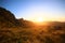 Beautiful bloming wild flowers fields and meadow in springtime on sunset and natural sunlight shining on mountain