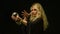 Beautiful blond astrologer woman looking through crystal ball.