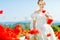 Beautiful blond bride in field with poppies