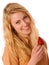 Beautiful blond cheerful caucasian woman eats a big red strawberrie isolated over white background