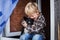 Beautiful blond child embrace his dog. Friendship between human and animal