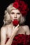 Beautiful blond girl in dress and hat with roses, classic makeup, curls, red lips. Beauty face.