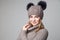 Beautiful blond girl wears winter pullover and hat