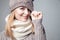 Beautiful blond girl wears winter scarf and hat
