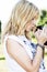 Beautiful blond hair woman kissing cute pet Peruvian guinea pig