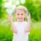 Beautiful blond little girl showing six fingers (her age)