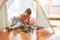 Beautiful blond toddler girl playing with constuction blocks inside tipi at kindergarten