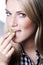 Beautiful blond woman biting a grape