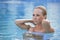 Beautiful Blond Woman In A Blue Swimming Pool