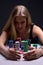 Beautiful blond woman with chips in casino