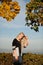 Beautiful blond woman outdoor on autumn afternoon with blue sky in background