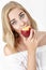 Beautiful blond woman with pleasure eating nectarine