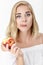 Beautiful blond woman with pleasure eating nectarine